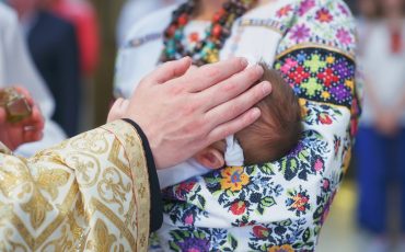 Christening newborn in church. Baby christening. Ceremony in Christian Church.